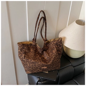 Detailed view of the leopard print canvas tote bag featuring an our fave brand label