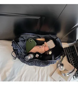 Top view of spacious interior of blue plaid canvas tote bag holding daily essentials