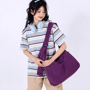 Detail of purple large-capacity drawstring shoulder bag with adjustable wide strap