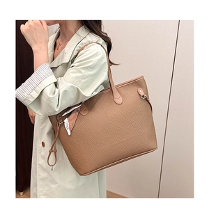 Brown tote bag with lychee texture leather and a white fashion decorative strap detail