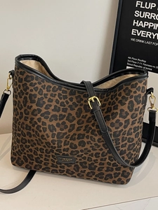 Vintage leopard print bucket tote bag with black leather straps and gold hardware