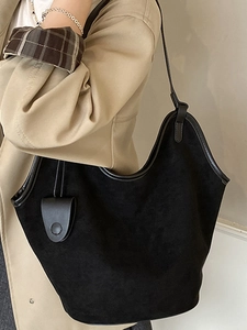 Minimalist black suede tote bag with leather straps and round charm for women