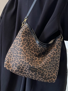 Vintage leopard print bucket tote bag with black leather trim and gold hardware