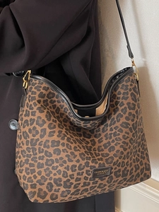 Vintage leopard print bucket bag with black straps and golden hardware for women