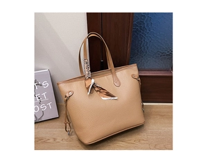 Close-up of khaki tote bag with lychee texture and fashion printed silk scarf
