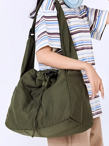 Olive green drawstring nylon shoulder bag with adjustable strap and side pockets for commuting
