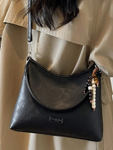 Retro black crossbody bag with beaded fringe and leather texture for women fashion