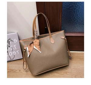 Detail view of large tote bag in dark brown lychee leather with silk scarf accessory