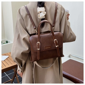 Deep brown vintage leather backpack showing adjustable straps and stylish messenger bag style