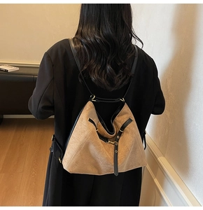 Brown vintage tote bag detail showing matte texture and double-shoulder carry style