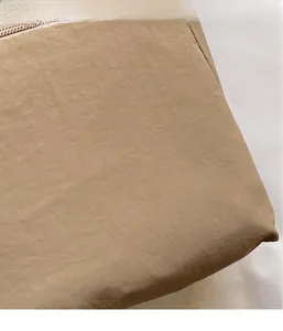 Detail of khaki lightweight washed canvas fabric with smooth zipper and durable texture