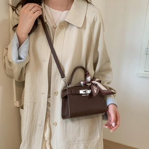 Classic dark brown pebble leather Kelly handbag with silk scarf and silver twist lock