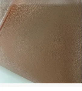 Close-up of brown litchi-grain leather texture with soft and high-gloss finish