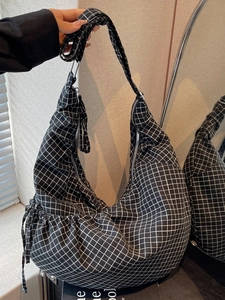 Large black and white checkered canvas hobo bag with drawstring and wide shoulder strap