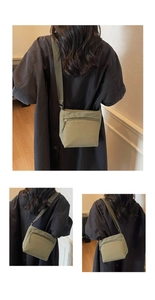 Detail view of the olive green nylon crossbody bag with adjustable strap and zip pocket