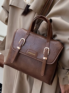Vintage brown leather crossbody messenger bag with golden buckles and top handle design