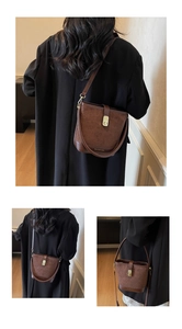 Detail of coffee bucket bag with quilted suede and smooth leather finishes