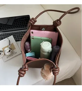 Top view of spacious brown litchi pattern tote bag showing interior storage and accessories
