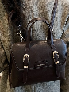 Vintage dark brown large capacity messenger backpack shown with a wool coat