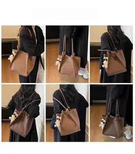 Brown faux leather tote bag with knotted handle detail and cute white bear charm