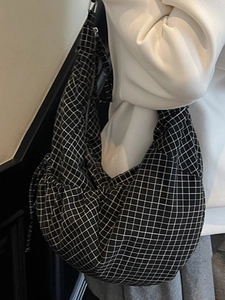 Minimalist black and white checkered canvas crossbody bag with drawstring detail