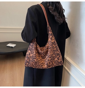 Lifestyle shot showing the vintage leopard print tote bag with brown leather shoulder straps