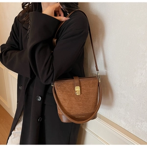 Detail view of vintage bucket bag with rhombic stitching and contrast textures