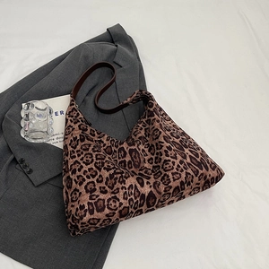 Close-up of deep brown leopard print tote bag with thick dark coffee leather straps