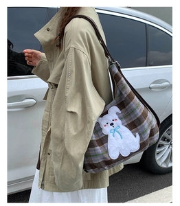 Detailed view of vintage plaid tweed tote bag with cute white puppy patch embroidery