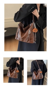 Detail of dark brown PU leather tote bag with silver star pendant and teddy bear charm