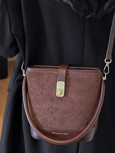 Vintage brown suede bucket bag with diamond stitching and stylish leather accents