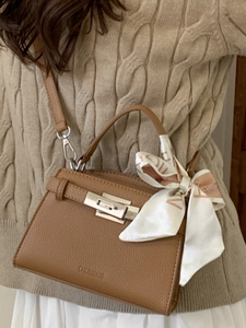 Brown leather trapezoid handbag with silver twist lock and decorative silk scarf handle