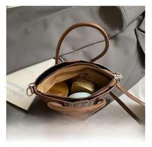 Top view detail of the brown woven bucket bag interior showing spacious storage capacity