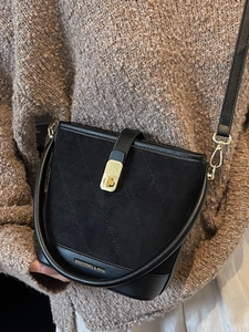 Retro black quilted bucket bag with gold lettering and shoulder strap for women
