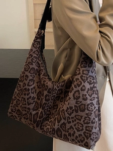 Large leopard print hobo shoulder bag with black wide strap and top zipper closure