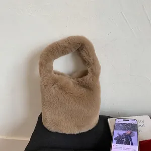 Detail of soft brown faux fur texture and bucket shape handle on this stylish handbag