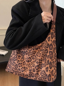 Fashionable leopard print tote bag with brown leather handles for stylish women commuting