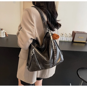 Detailed view of black Hobo bag in PU leather with star zipper and bear charm