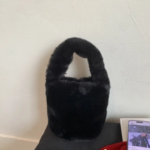 Close-up of the plush black faux fur texture on this trendy minimalist bucket handbag