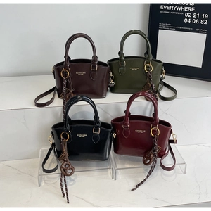 Collection of glossy leather crossbody bags in coffee, green, black and burgundy colors