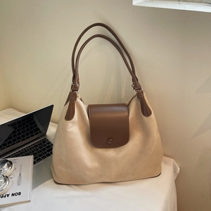 Close-up of cream large-capacity Hobo bag with brown leather straps and buckle detail