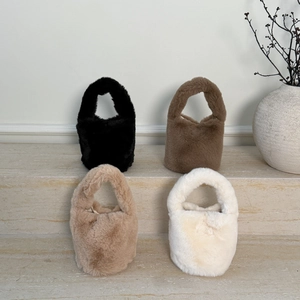 Detail showing four colors of plush bucket bags: black, brown, camel, and off-white textures