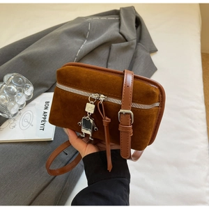 Brown faux suede crossbody bag with robot charm detail and adjustable leather strap