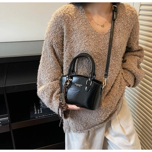 Mini black patent leather Boston bag with charm detail and adjustable shoulder strap