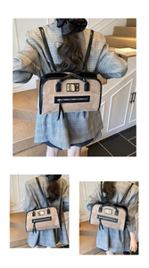 Detail of khaki suede patchwork shoulder bag with black leather trim and metal hardware