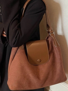Large warm brown suede and leather tote bag shown on a model for daily commuting style