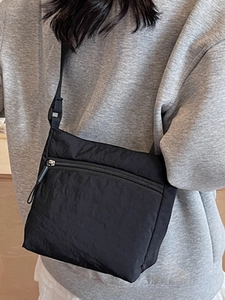 Minimalist black washed canvas crossbody bag with adjustable strap for casual wear