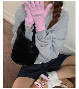 Chic autumn plush bucket bag in black fur texture with pink knit gloves detail