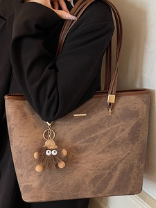 Large brown tote bag with marble texture and plush charm for student commute wear