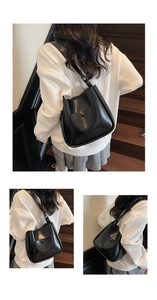 Detailed macro view of black glossy PU leather bucket bag with metallic snap button closure